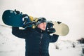 Happy young man with snowboard enjoying sunny weather in snowy mountains. Winter sport and recreation, leasure outdoor activities Royalty Free Stock Photo