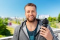 happy young man with sports bottle