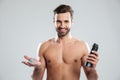 Happy young man standing isolated holding shaving foam. Royalty Free Stock Photo