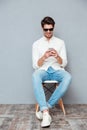 Happy young man in sunglasses listening to music from smartphone Royalty Free Stock Photo