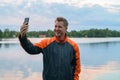 Happy Young Man Taking Selfie With Phone By The Lake Royalty Free Stock Photo