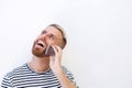 Happy young man talking on cell phone against white background Royalty Free Stock Photo