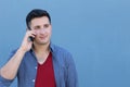 Happy young man talking on cell phone isolated on blue background Royalty Free Stock Photo