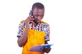 Happy young man talking on mobile phone with clipboard Royalty Free Stock Photo