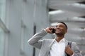 Happy young man talking on mobile phone inside building Royalty Free Stock Photo