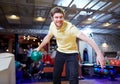 Happy young man throwing ball in bowling club Royalty Free Stock Photo