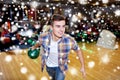 Happy young man throwing ball in bowling club Royalty Free Stock Photo