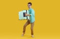 Happy young man traveler in sunglasses carrying suitcase Royalty Free Stock Photo