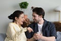 Happy young man using cellphone with mature mother. Royalty Free Stock Photo