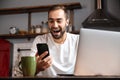 Happy young man using laptop computer Royalty Free Stock Photo