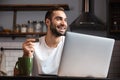 Happy young man using laptop computer Royalty Free Stock Photo