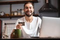 Happy young man using laptop computer Royalty Free Stock Photo