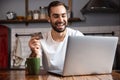 Happy young man using laptop computer Royalty Free Stock Photo