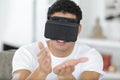Happy young man using virtual reality mask at home Royalty Free Stock Photo