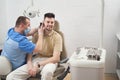 Happy young man visiting doctor in office