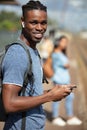 happy young man waiting for train at station with bag Royalty Free Stock Photo