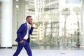 Happy young man walking and talking on mobile phone Royalty Free Stock Photo