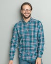 happy young man wearing checkered shirt and glasses and smiling Royalty Free Stock Photo