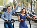 Happy young man and woman with electrkc bikes