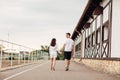 Happy young man and woman are having fun outdoors on a warm summer day. couple walking near horse rancho Royalty Free Stock Photo