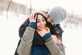 A happy young man and woman kissing in winter enjoying life and