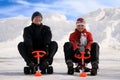 Happy young man and woman riding snowmobiles Royalty Free Stock Photo