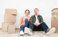 Happy young man and woman sitting near cardboard boxes Royalty Free Stock Photo