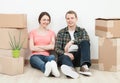 Happy young man and woman sitting near cardboard boxes Royalty Free Stock Photo