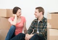 Happy young man and woman sitting near cardboard boxes Royalty Free Stock Photo