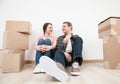 Happy young man and woman sitting near cardboard boxes Royalty Free Stock Photo