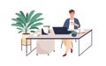 Happy young man working with laptop at desk, holding cup of coffee. Office worker at modern workplace with plants