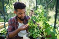 Happy young man working outdoors in backyard, gardening and greenhouse concept. Royalty Free Stock Photo