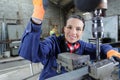 happy young mechanic apprentice working on milling machine Royalty Free Stock Photo