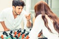 Happy couple playing foosball table. Royalty Free Stock Photo