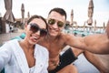 Funny young lady posing for selfie with boyfriend and showing her tongue Royalty Free Stock Photo