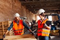 The woman inspector checks the work of a man in a warehouse Royalty Free Stock Photo