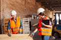 The woman inspector checks the work of a man in a warehouse Royalty Free Stock Photo