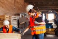 The woman inspector checks the work of a man in a warehouse Royalty Free Stock Photo