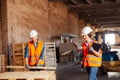 The woman inspector checks the work of a man in a warehouse Royalty Free Stock Photo