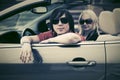 Happy young couple driving convertible car Royalty Free Stock Photo