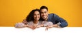 Happy Young Middle Eastern Couple Leaning At Big White Advertisement Board Royalty Free Stock Photo