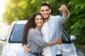 Happy young middle-eastern couple showing brand new car key Royalty Free Stock Photo
