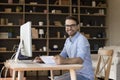 Happy young millennial business man in glasses working on project Royalty Free Stock Photo
