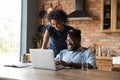 Happy young mixed race african family couple using computer. Royalty Free Stock Photo