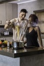 Happy young mixed race couple cooking dinner in kitchen Royalty Free Stock Photo
