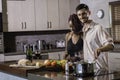 Happy young mixed race couple cooking dinner preparing food in the kitchen Royalty Free Stock Photo