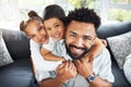 Happy young mixed race dad bonding with his adorable children in a living room at home. Cute Hispanic son and daughter Royalty Free Stock Photo