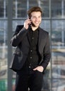 Happy young modern man talking on mobile phone Royalty Free Stock Photo