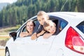 Happy young mom and her children sitting in a car Royalty Free Stock Photo