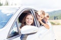 Happy young mom and her children sitting in a car Royalty Free Stock Photo